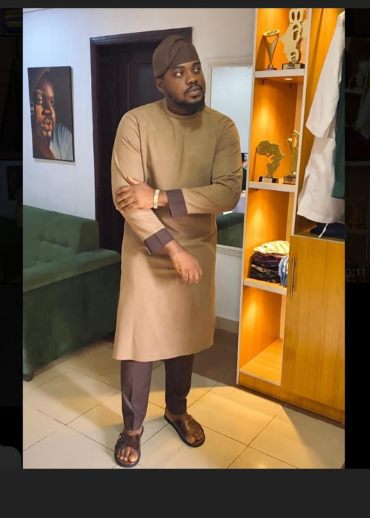 Man wearing African traditional clothing. bronze shirt and brown pants