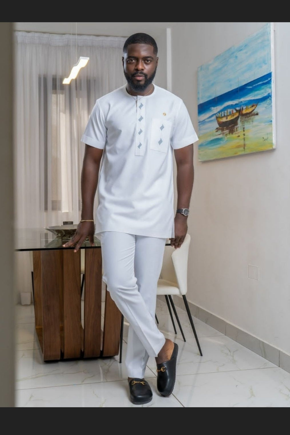 man in white african wear for baby christening event