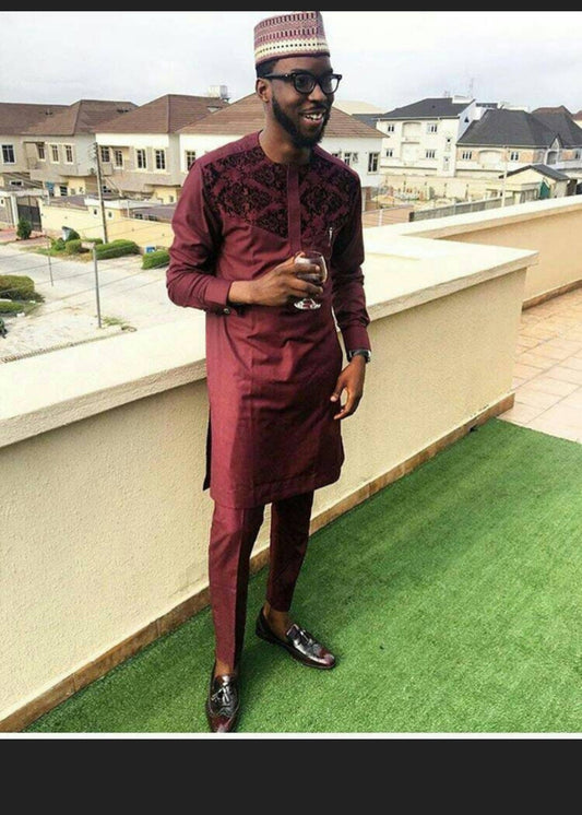 man elegantly styled in African suit. burgundy color.