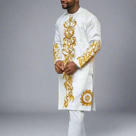 a well groomed man dressed in luxury kaftan. white and gold embroidered African suit. long sleeved top and pant for weddings, church, and all occasions. shop at finessestitches.com